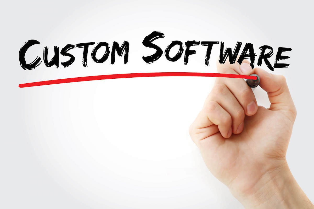 Hand underlining the words “Custom Software.”