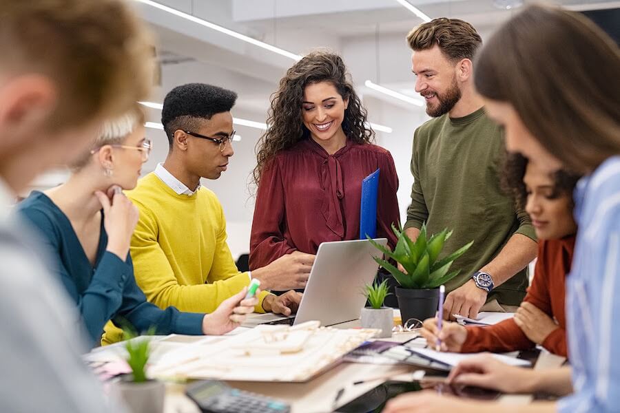 Group of young business professionals smiling and working at a conference table