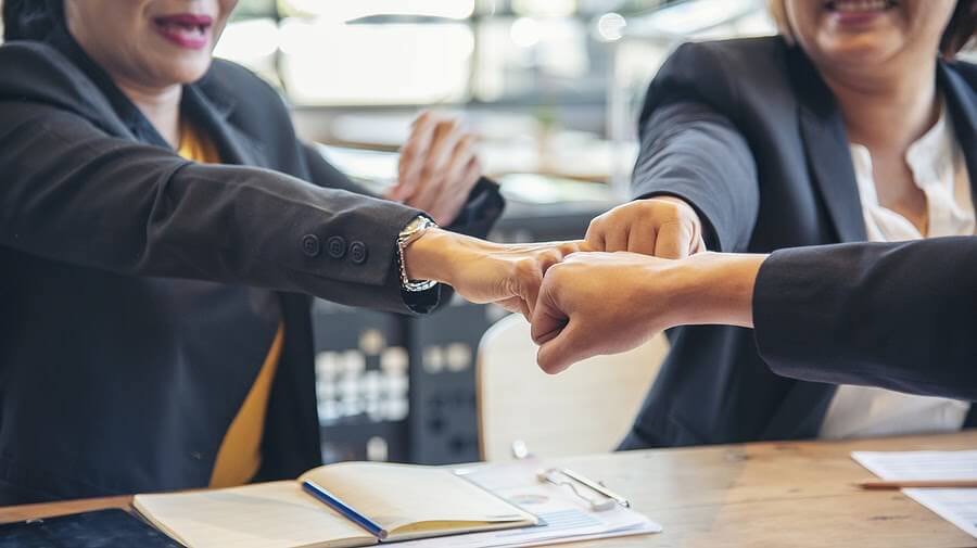 Group of diverse business professionals fist pumping