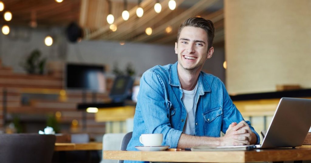 Man working remotely in a coffee shop.