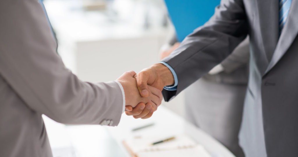 Two men shaking hands.