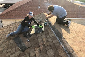 two men putting shingles to the roof